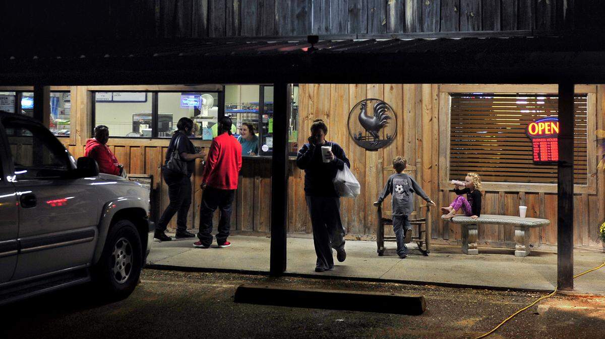 Business hums at the nearby Rooster's Road House Grill in Pine Hill.