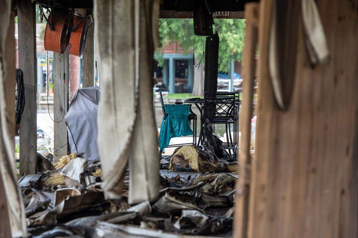 A metal chair and table set remains under one of two houses that caught fire Saturday night on Highway 603 in the Kiln.