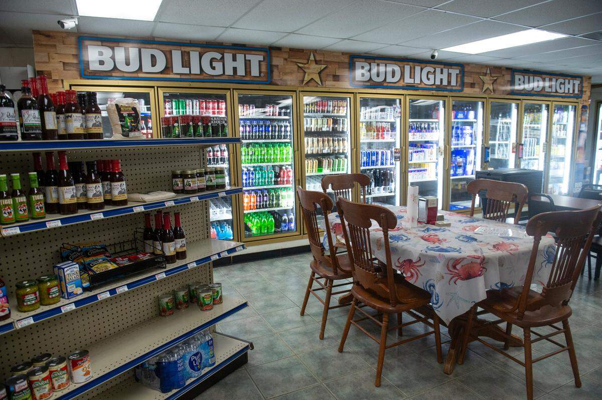 The grocery area inside Woolmarket Grocery in Biloxi has cold beer and fresh seafood to go.