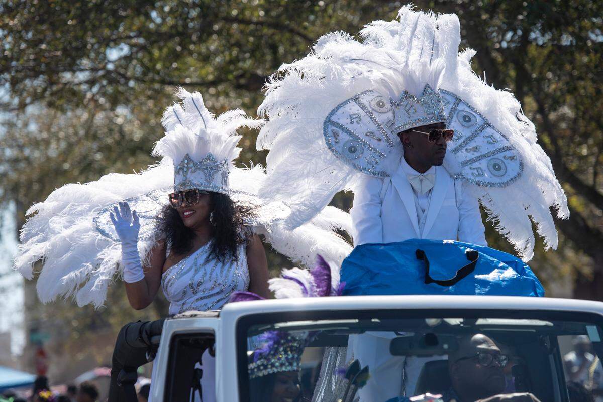A king and queen wave to the crowd during the Jackson County Carnival Association Mardi Gras parade in Pascagoula on Saturday, March 1, 2025.