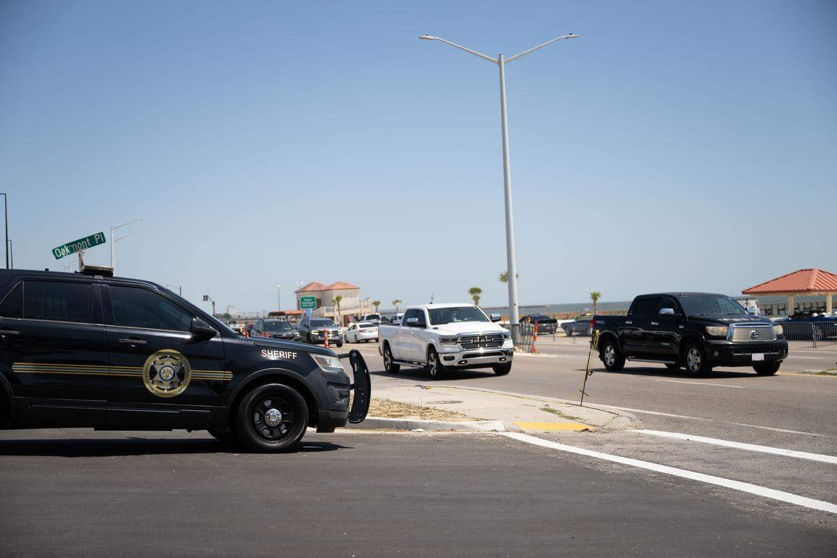 A Harrison County Sheriff’s Department patrol car is parked Saturday on the side of Beach Boulevard during Black Spring Break.