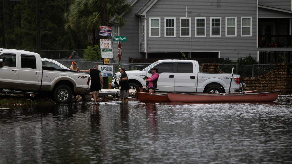 Residents of Pontiac Drive in the Jourdan River Shores community in Kiln used a canoe to get to safety after Hurricane Ida caused more than 8 feet of storm surge in the area on Aug. 30, 2021.