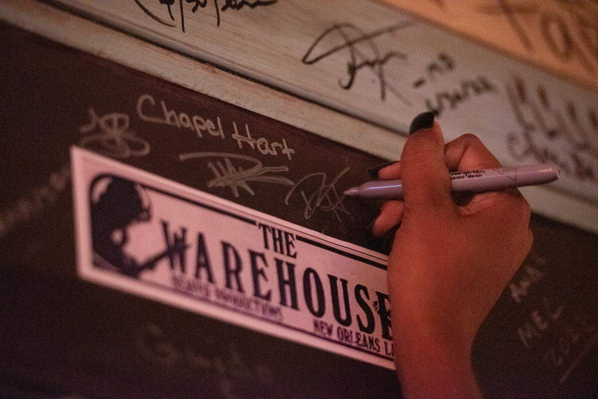 Chapel Hart signs their names on “The Porch” at Ground Zero Blues Club in Biloxi on Wednesday, Nov. 30, 2022. Every artist that performs at Ground Zero is asked to sign the wall.