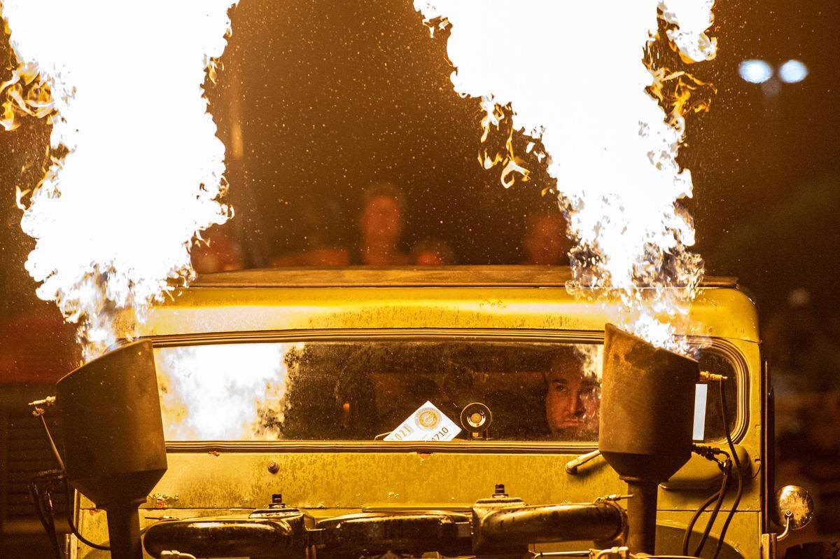 Cody McDaniel watches flames shoot out of his Jeep DJ5 during a flame throwing competition, where drivers compete to see which car can produce the biggest flames, at Island View Casino in Gulfport during Cruisin’ The Coast on Tuesday, Oct. 5, 2021.