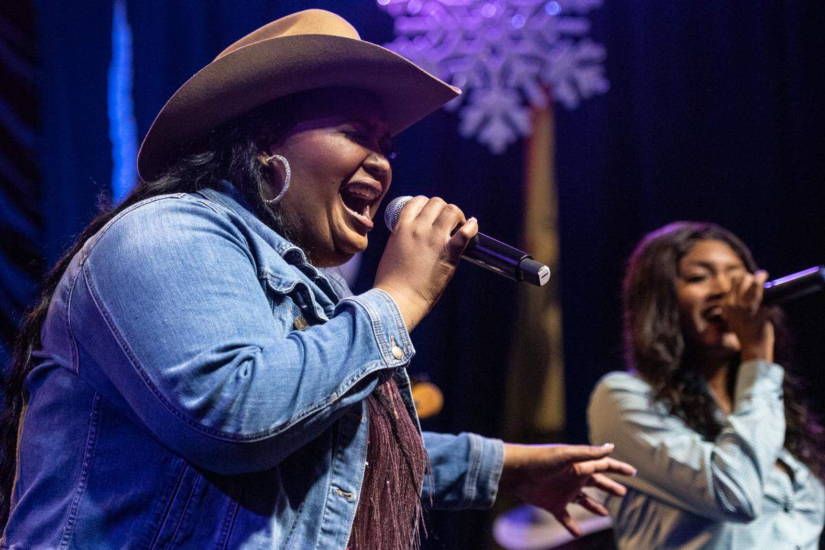 Chapel Hart sisters Danica and Devynn Hart sing next to each other during their show at Ground Zero Blues Club in Biloxi on Wednesday, Nov. 30, 2022.