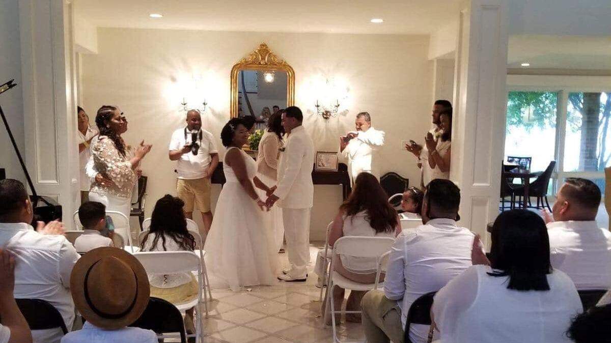 Dulce and Ariel Gonzalez exchange vows at a makeshift altar set up inside the Strunks' home.
