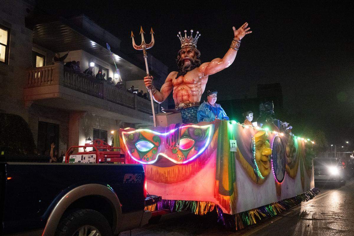 A parade float with a statue of Neptune drives down Howard Avenue during the Krewe of Neptune parade in Biloxi on Saturday, Feb. 14, 2026.