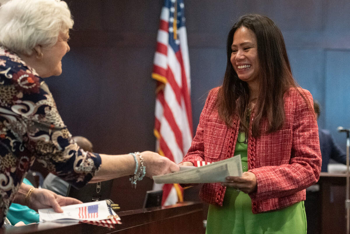 Lani Edwards, an immigrant from the Philippines, smiles as she receives her naturalization documents and an American flag during a naturalization ceremony at Dan M. Russell Courthouse in Gulfport on Thursday, Oct. 19, 2023.