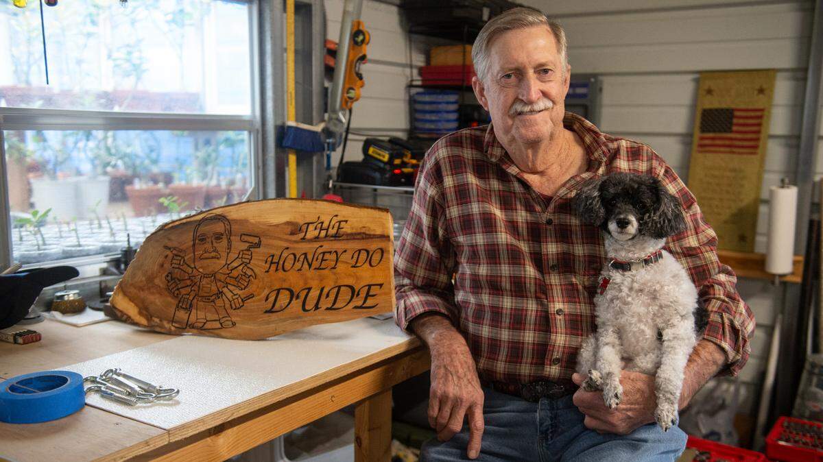 Daniel “Danny” Chauvin, also known as the “Honey Do Dude”, poses for a portrait in his workshop with his dog Panda at his home in Waveland on Thursday. Chauvin decided to offer free repair work to those who need it after his wife passed away in 2022.