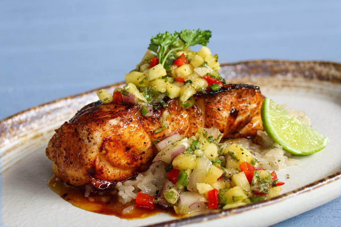 The Margarita Grouper dish at Catch 110 which features fresh grouper topped with key lime, orange, tequila, pineapple salsa on a bed of coconut lime rice.
