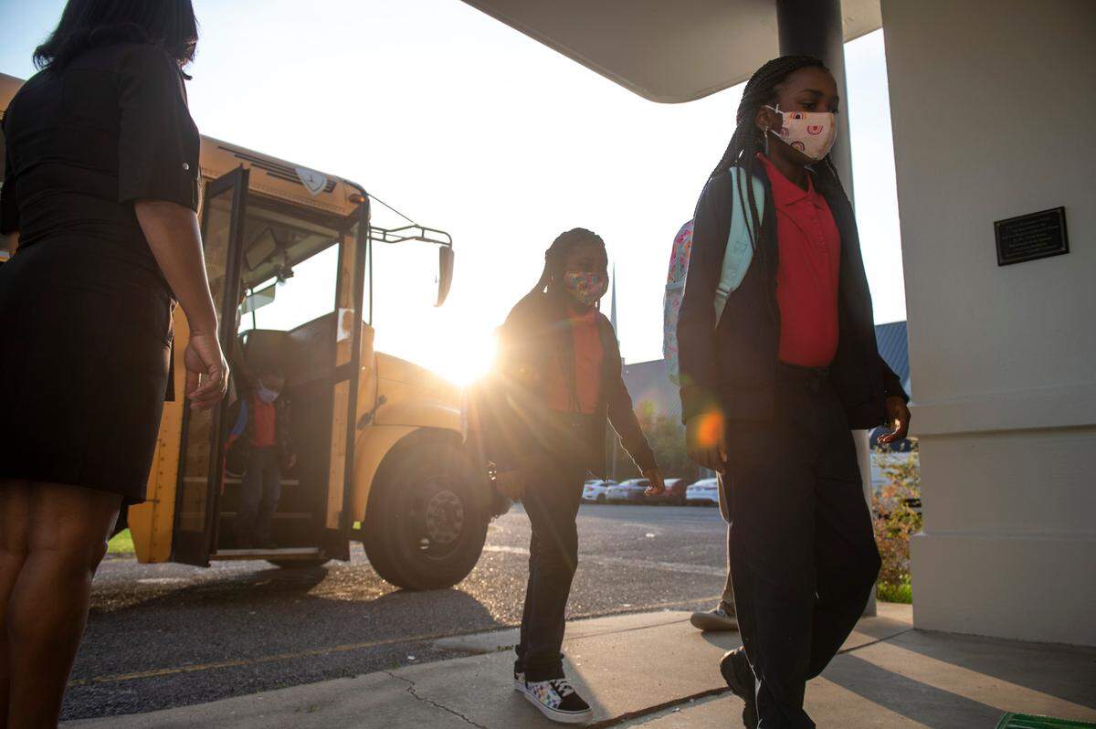 Elementary students arrive off the bus for their first day of the school year at Gautier Elementary School in Gautier on Monday, July 5, 2021.