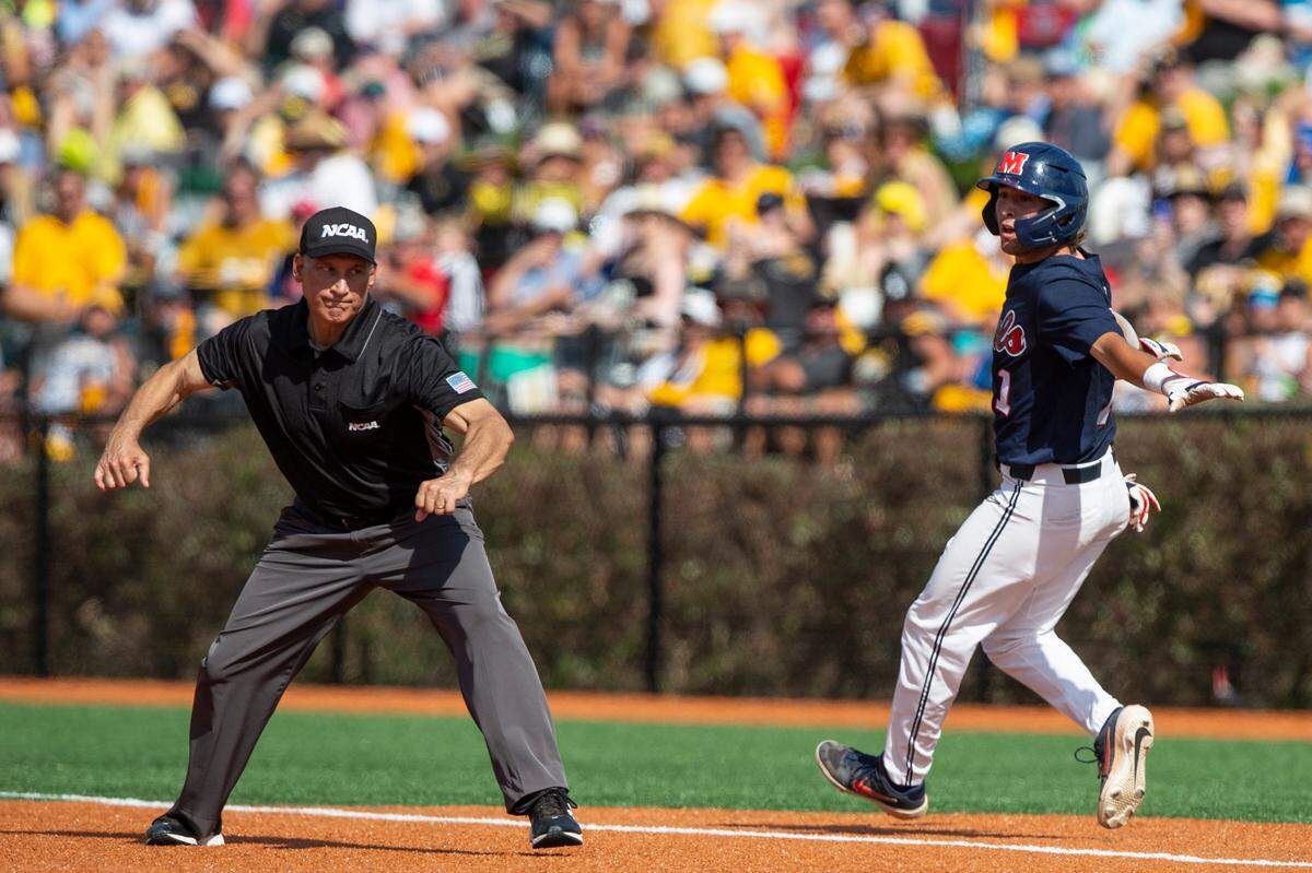 An umpire calls out Ole Miss’s Peyton Chatagnier as he runs to first base during the Super Regionals Final at Pete Taylor Park in Hattiesburg on Sunday, June 12, 2022.