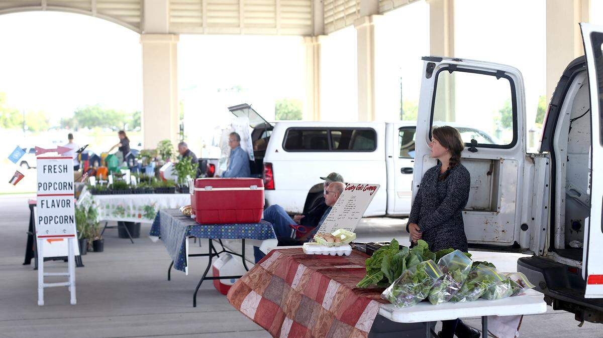AMANDA McCOY/SUN HERALDFresh herbs, fresh-caught local shrimp, locally made flavored popcorn, fresh greens and radishes, dairy products, locally made tamales, local honey, locally baked bread and bird feeders were all on sale at the Gulfport Harbor Farmers Market last week.