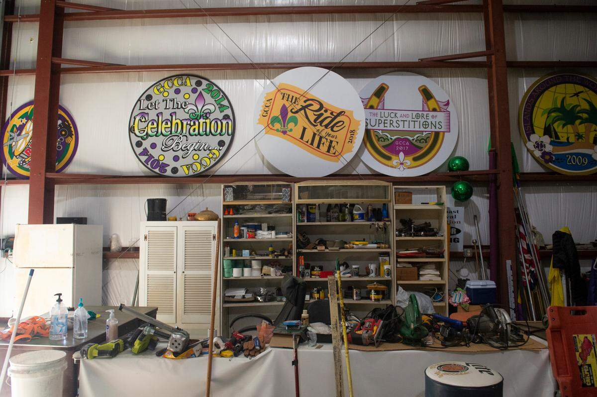 Signs with parade themes from past years line the walls at the Gulf Coast Carnival Association float den in Biloxi on Wednesday, Jan. 10, 2024.