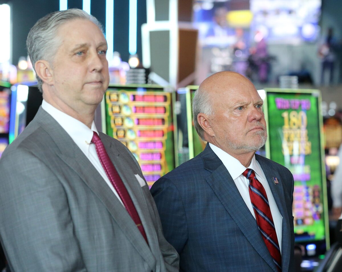 Island View Casino Resort owners Terry Green, left, and Rick Carter listen to speakers before the ribbon cutting of their new non-smoking casino in Gulfport on Thursday, June 21, 2018.