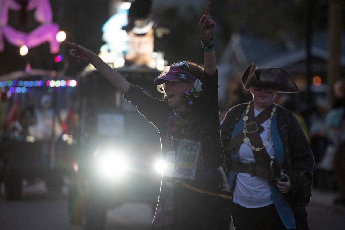 Members of Mystic Krewe of the Seahorse throw beads during the krewe’s Lundi Gras parade in Bay St. Louis on Monday, March 3, 2025.