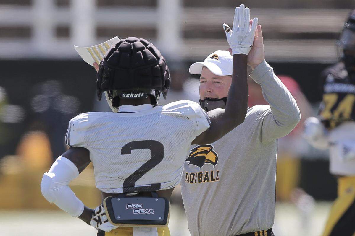 Southern Miss wide receiver Da’quan Bailey-Brown (2) high-fives head coach Will Hall at practice on Saturday, March 6, 2021 in Hattiesburg.