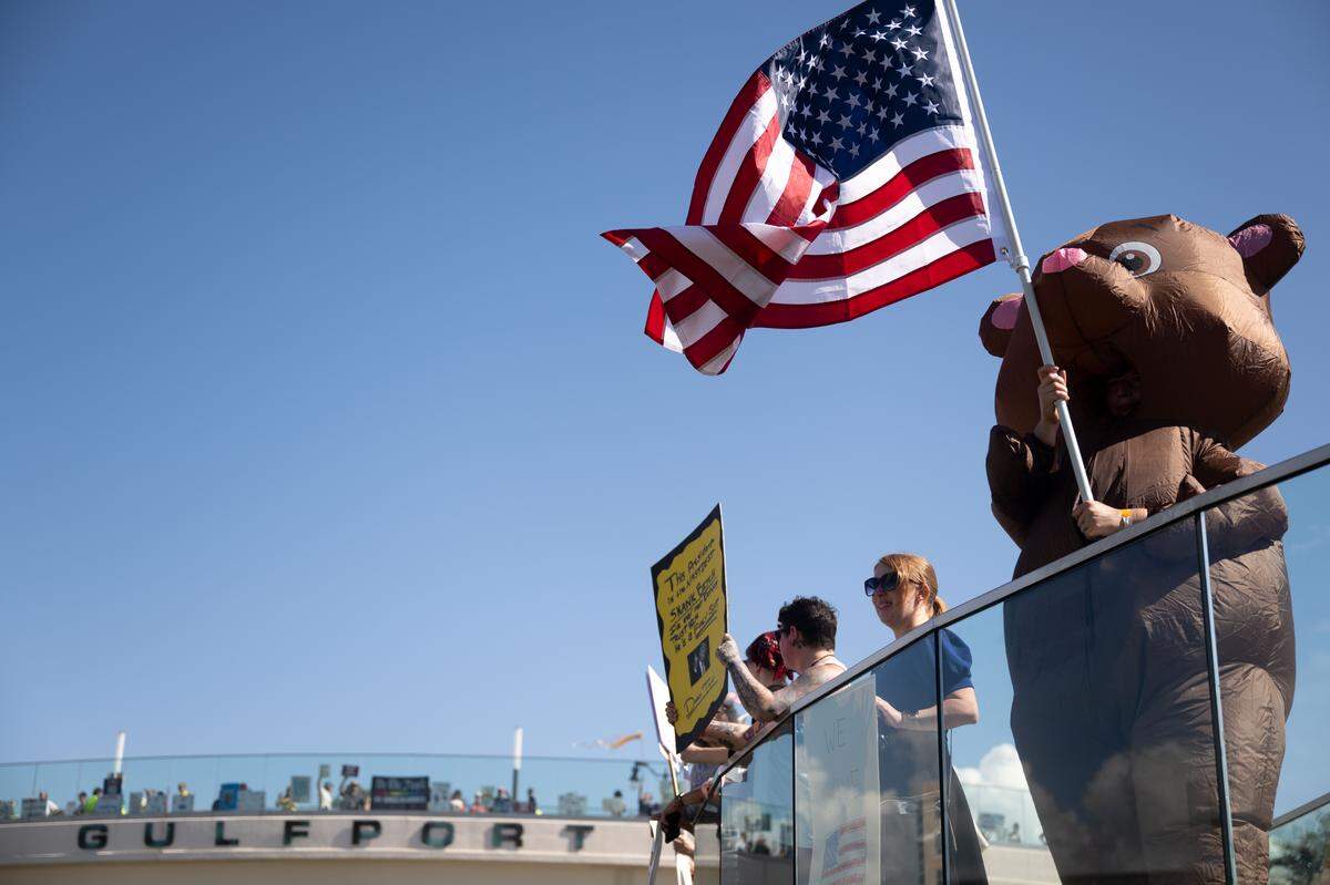 Protesters gather Saturday on a bridge to Jones Park.