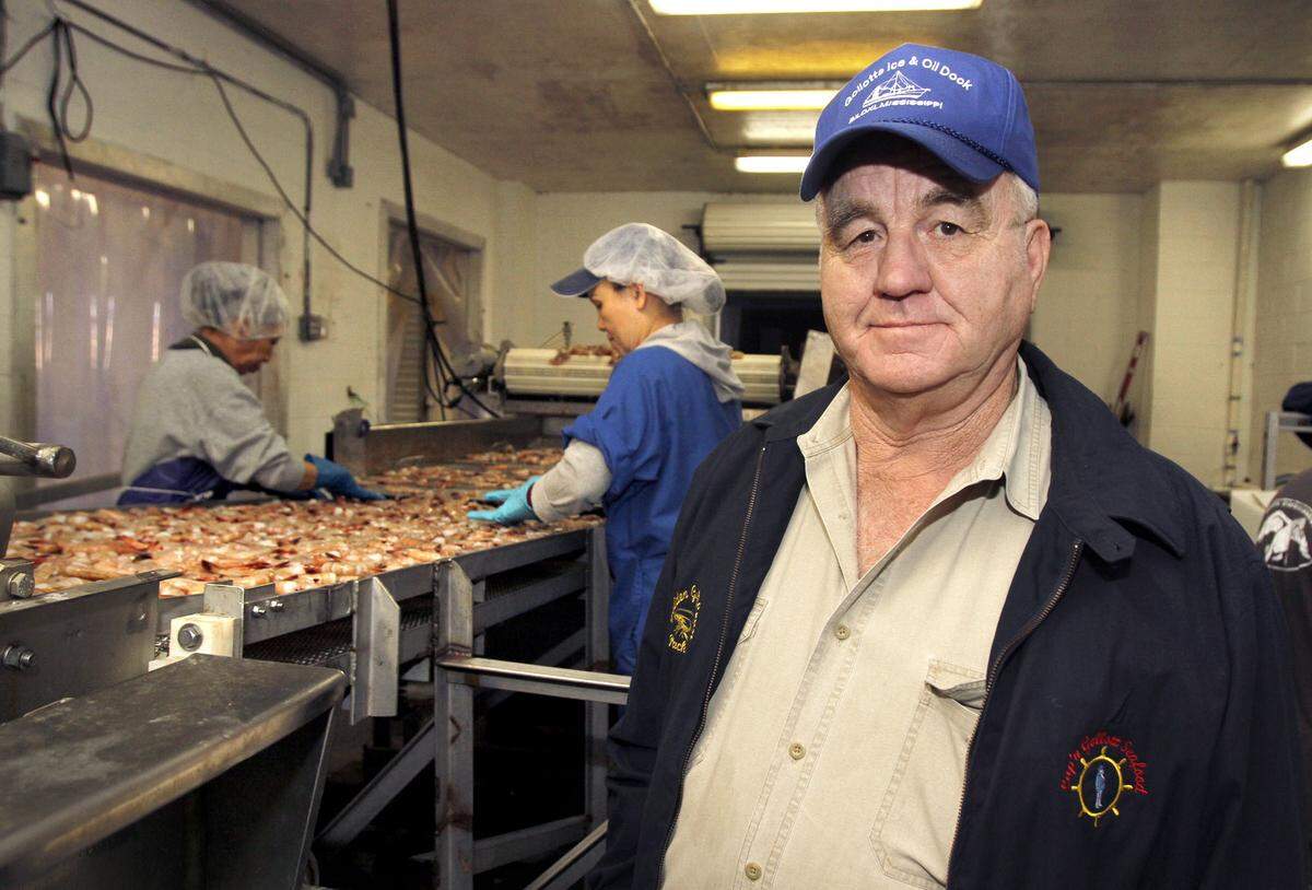 TIM ISBELL/SUN HERALD Richard Gollott looks on as Ngot Thi Huynh and Phuc Nguyen process shrimp at Golden Gulf Coast Packing Company in Biloxi, Miss.