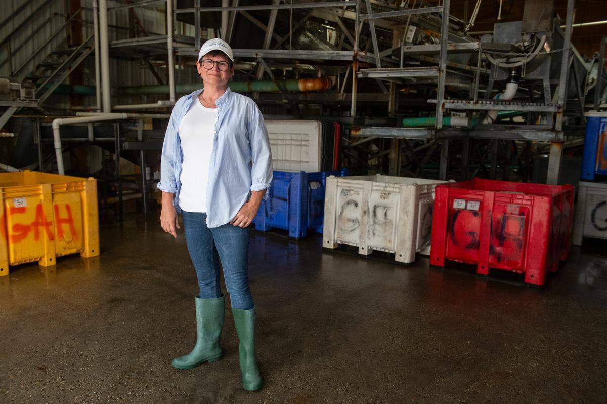 Bethany Fayard, who has been working for her family’s shrimp company, Ocean Springs Seafood, for 10 years, stands inside Biloxi Bay Processing in Biloxi.