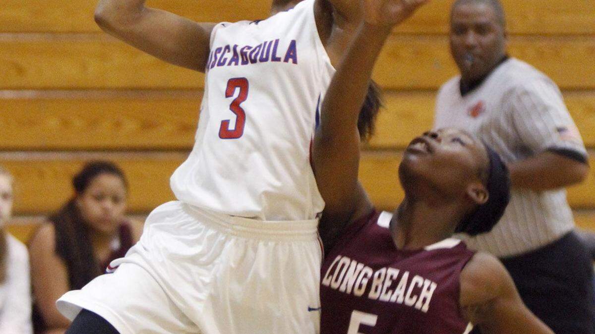 TIM ISBELL/SUN HERALD 
 Pascagoula's Alexis McBeath drives the lane against Tytianna Burage of Long Beach, Monday, Feb. 15, 2016.