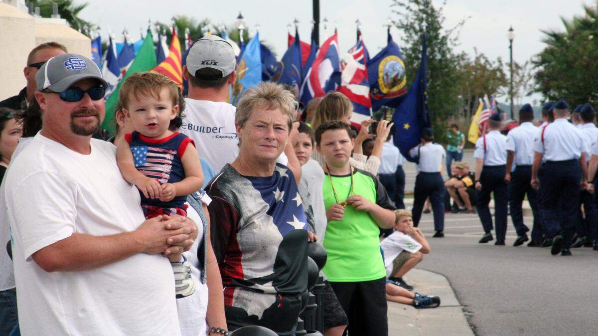 SHANNON DAVIDSON/SPECIAL TO THE SUN HERALD 
 Retired United States Air Force Veteran Tim Wiedermann, of Ocean Springs, with his son Calvin and mother Linda Wiedermann attend the 15th Annual Gulfport Veteran's Day Parade at Jones Park Saturday November 7.