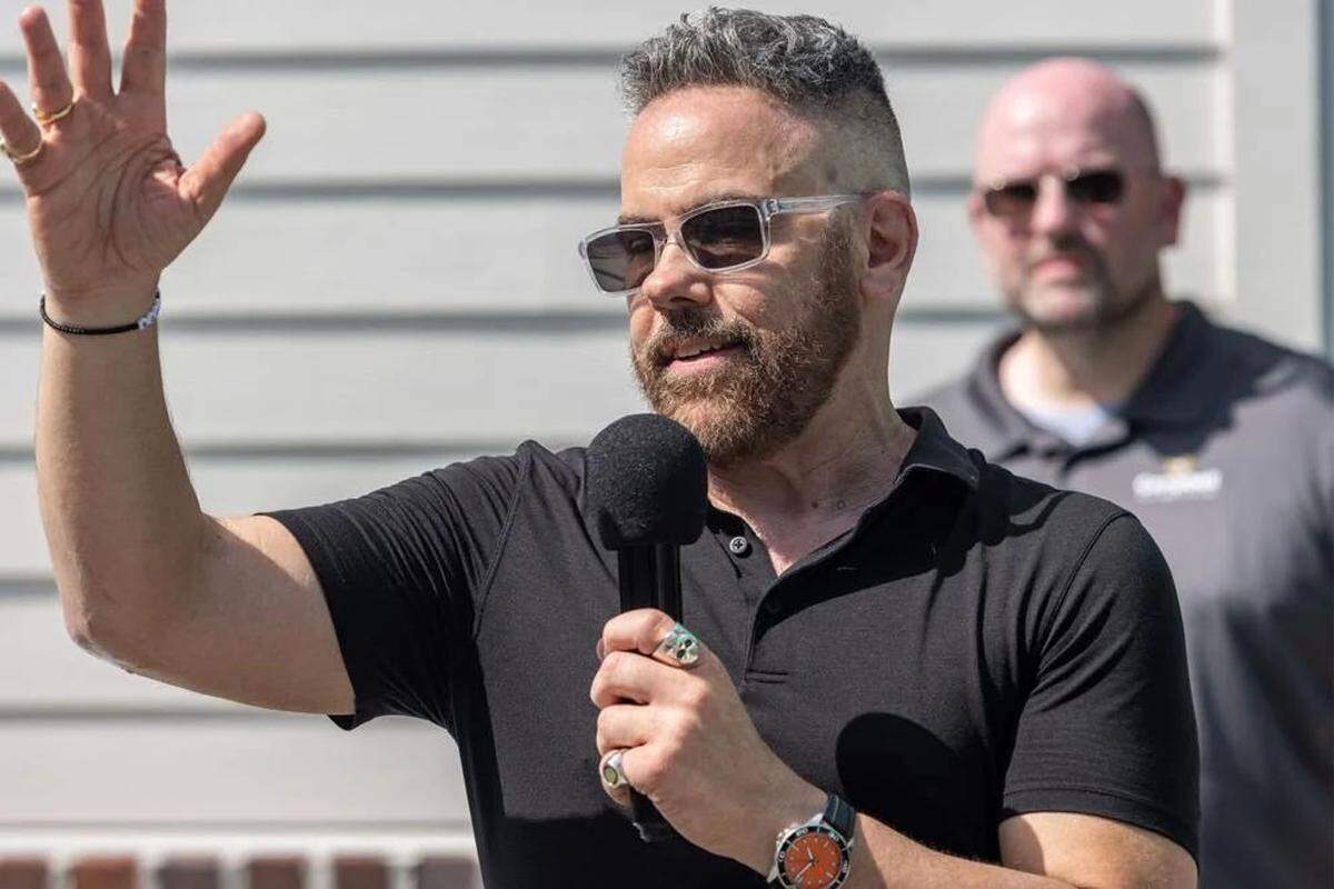 Josh Morgerman, a storm chaser known as iCyclone, speaks to guests at his “hurricane house” party on June 7, 2025.