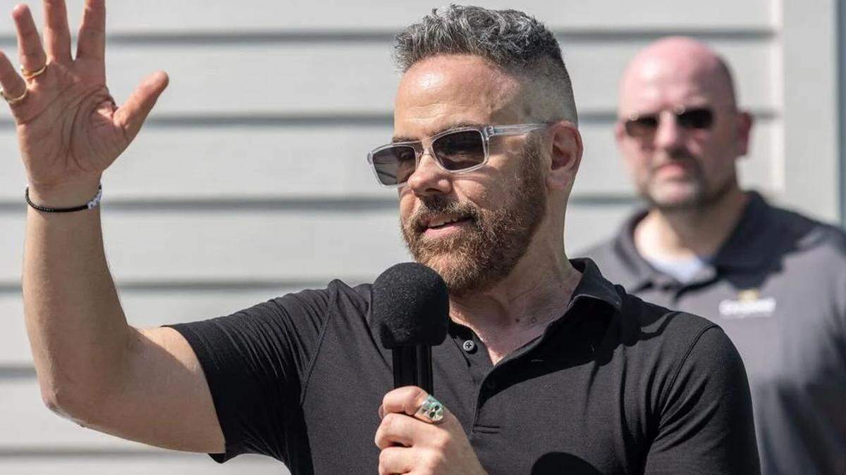 Josh Morgerman, a storm chaser known as iCyclone, speaks to guests at his “hurricane house” party on June 7, 2025.