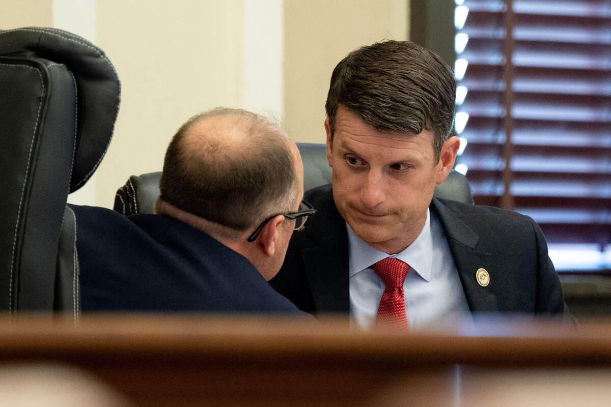 Assistant District Attorneys Matthew Burrell, right, and Chris Daniel, left, speak to each other Friday.