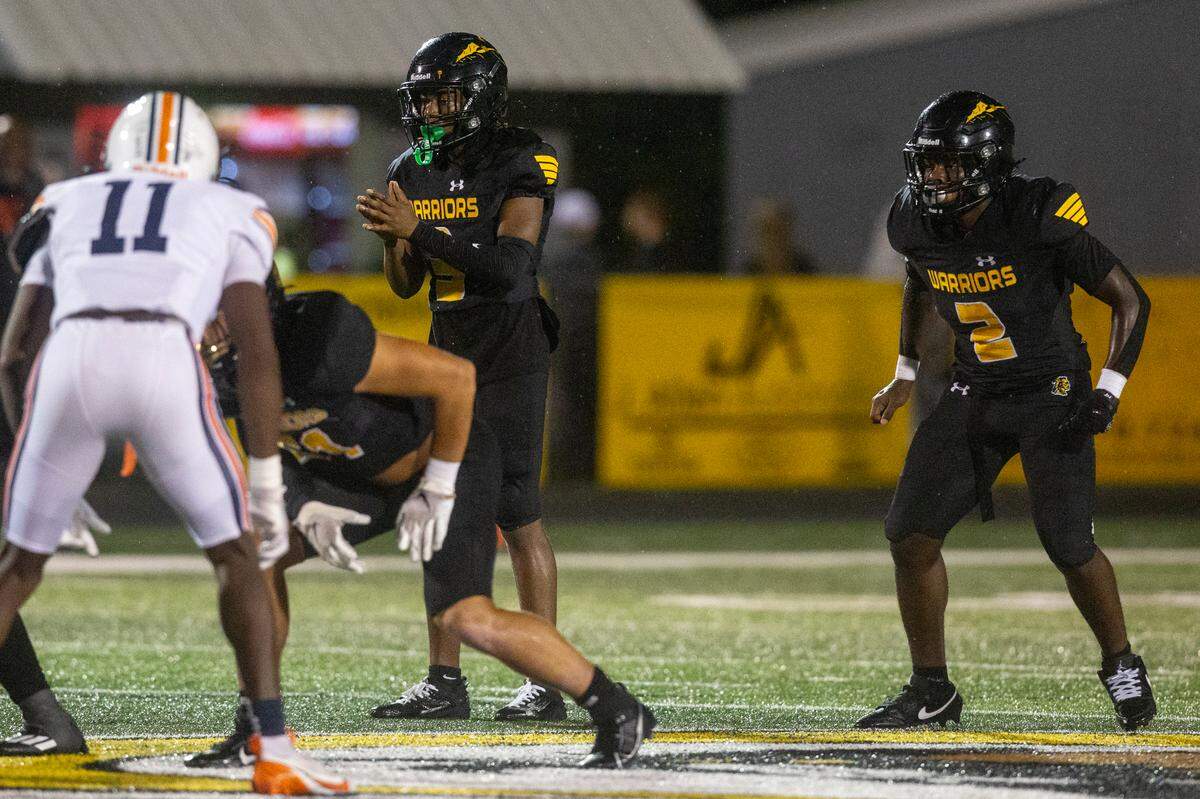 D’Iberville’s Jordan Walley and Jaquan Havard wait for the snap during a game between D’Iberville and Wayne County at Warrior Stadium in D’Iberville on Friday, Oct. 4, 2024.