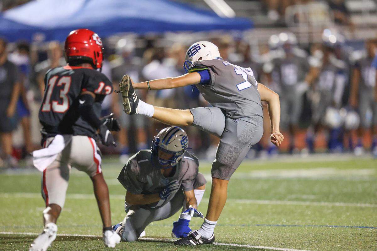 Ocean Springs Greyhounds Bart Edmiston (34) kicks the go ahead extra point in the second overtime during the Ocean Springs vs Clinton football game at Hugh Pepper Field, Ocean Springs, MS, Thursday, August 25, 2021.