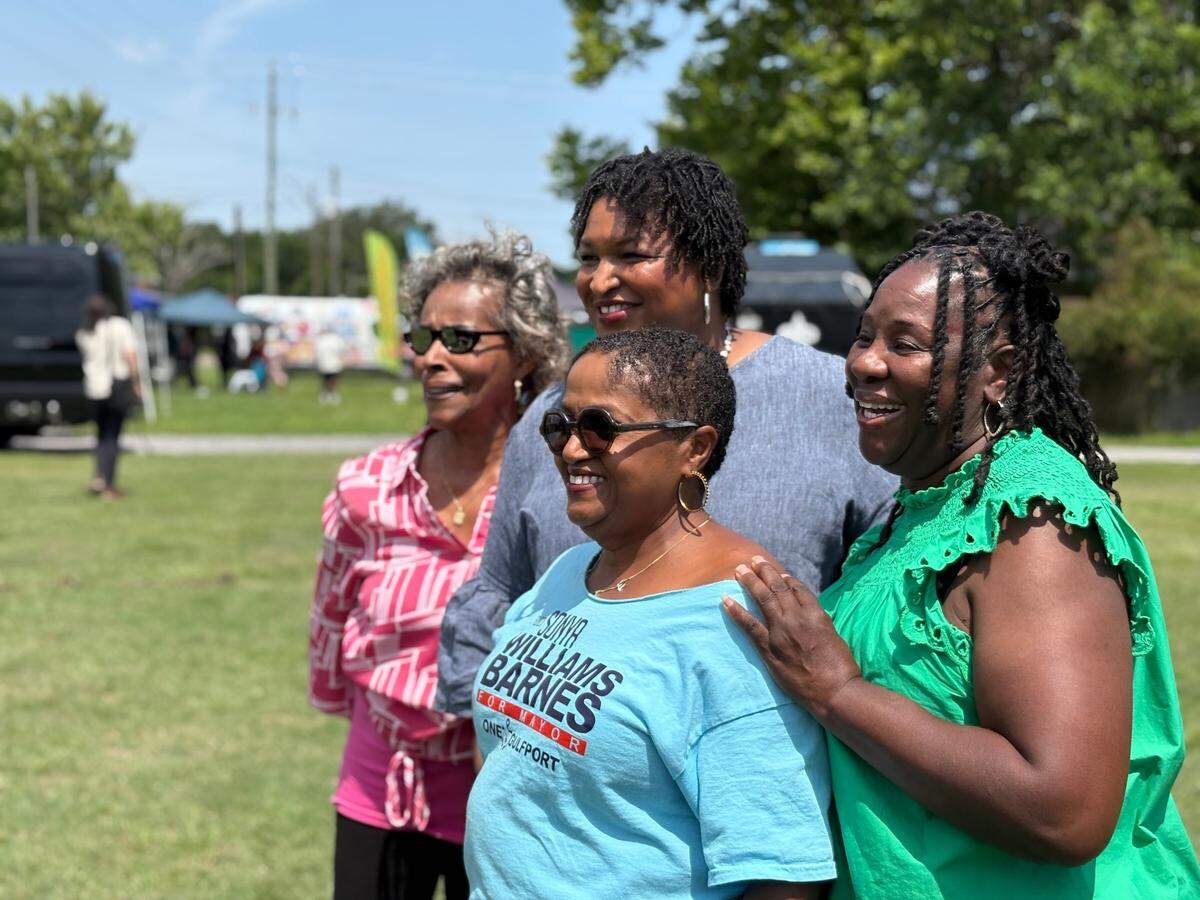 Mayoral candidate Sonya Williams Barnes and Democratic operative Stacey Abrams pose for a photo with supporters on June 1 at a campaign event in Gulfport. 