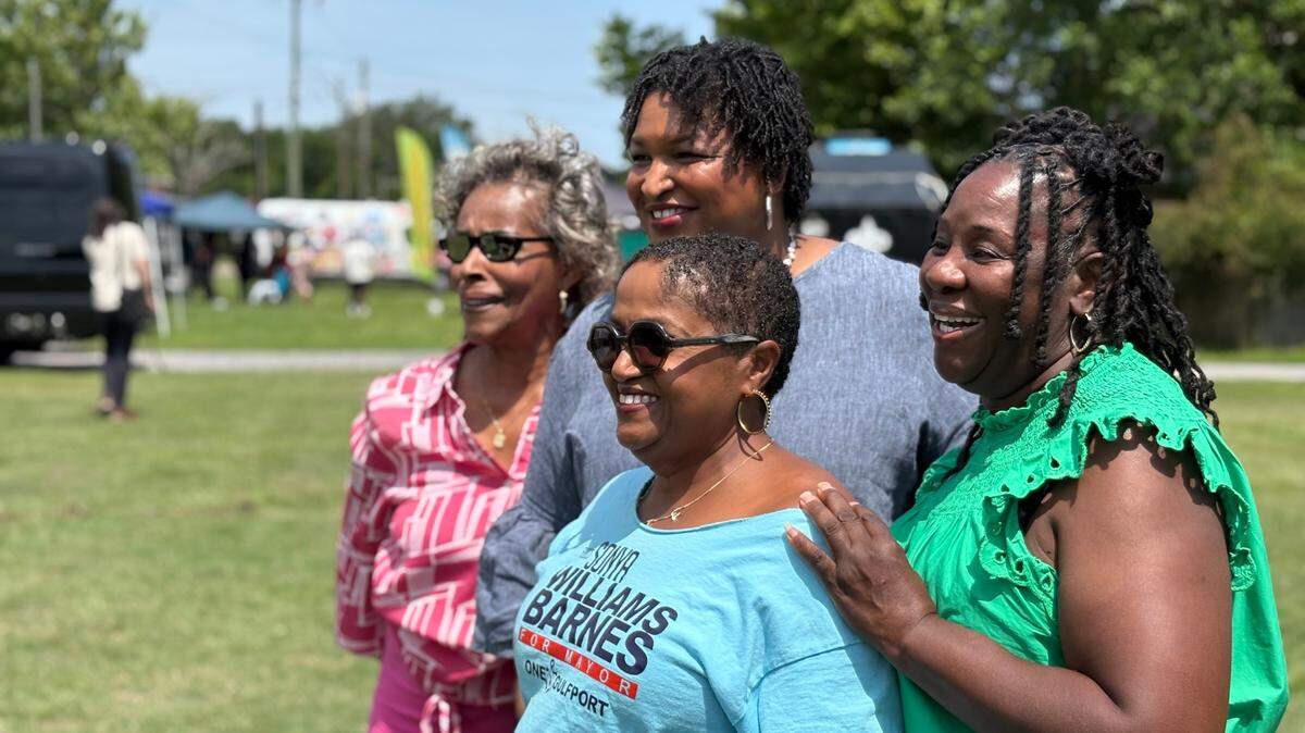 Mayoral candidate Sonya Williams Barnes and Democratic operative Stacey Abrams pose for a photo with supporters on Sunday, June 1 at a campaign event in Gulfport. 