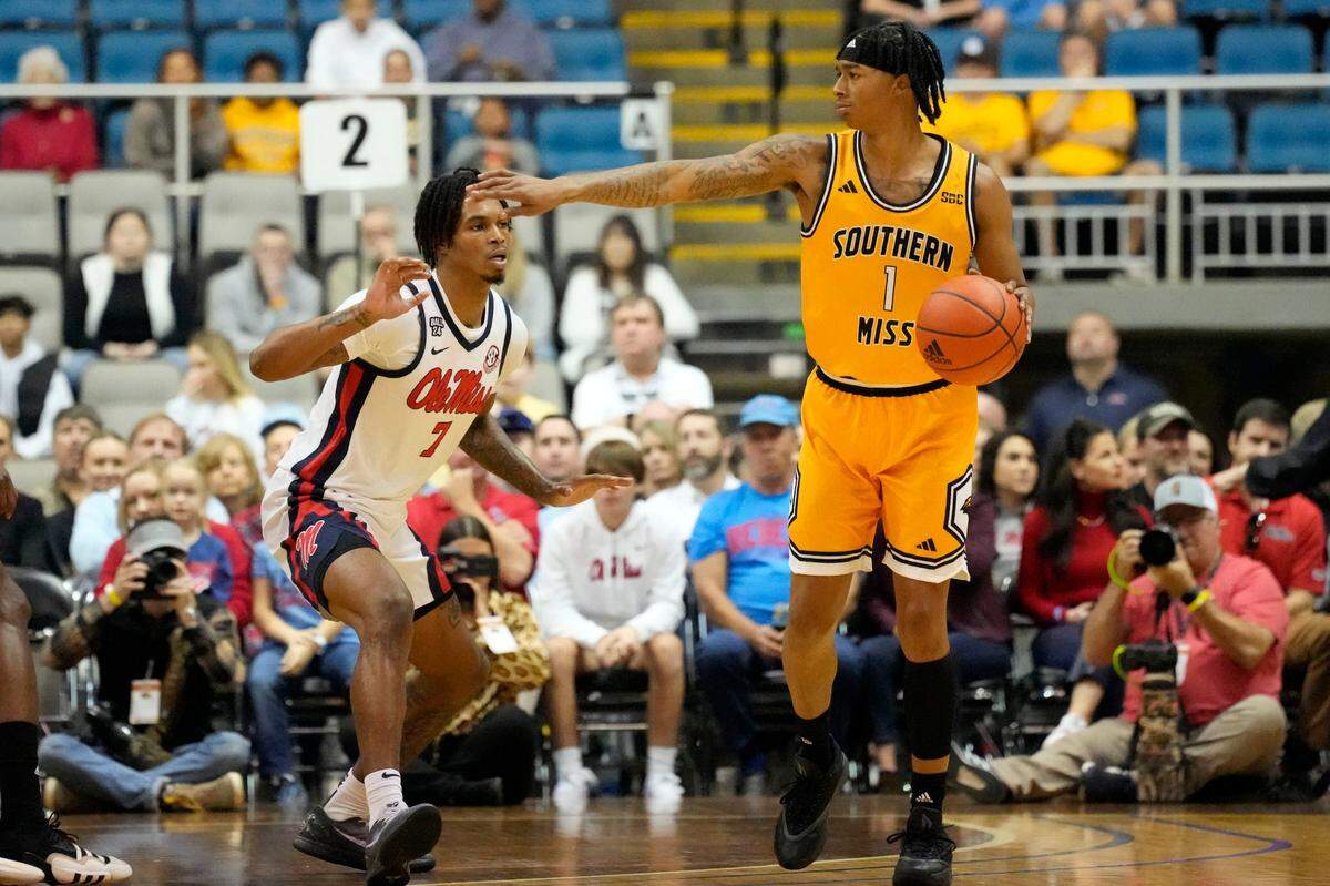 Southern Mississippi guard Austin Crowley (1) directs his teammates as Mississippi guard Allen Flanigan (7) defends during the first half of an NCAA college basketball game, Saturday, Dec. 23, 2023, in Biloxi, Miss. (AP Photo/Rogelio V. Solis)
