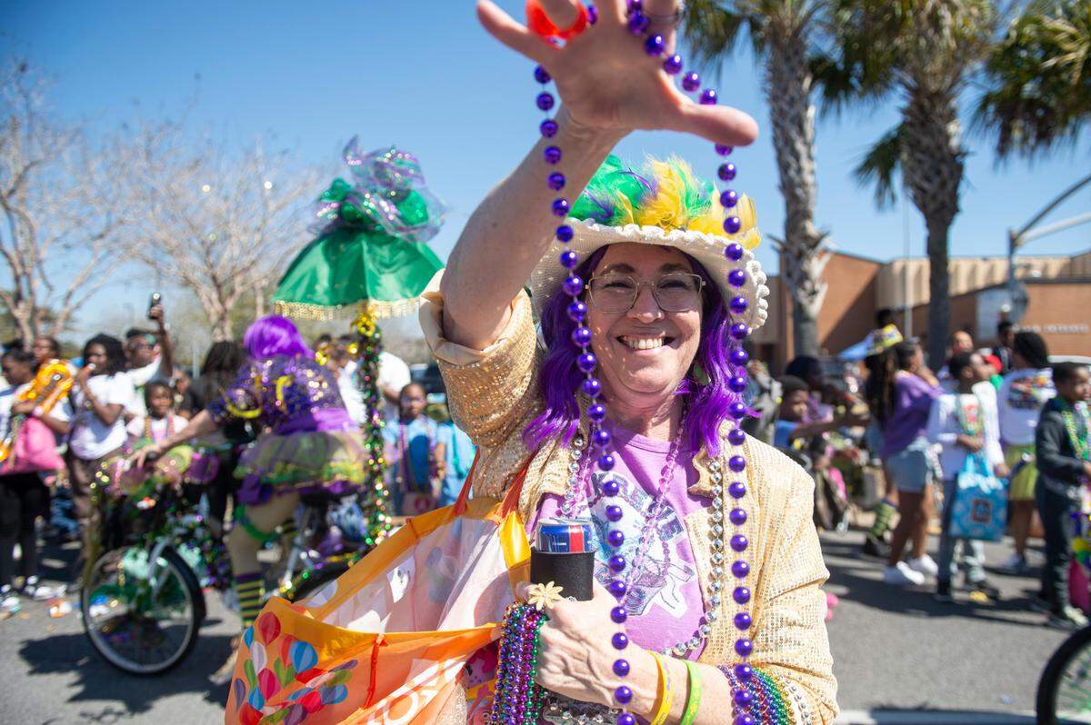 Krewes toss beads and other throws during the Jackson County Carnival Association Mardi Gras parade in Pascagoula in 2025.