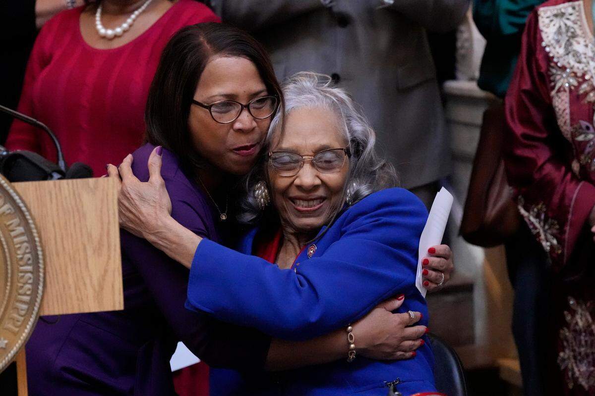 Former Mississippi State Rep. Alyce Clarke, D-Jackson, right, hugs State Rep. Tamarra Grace Butler-Washington, D-Jackson, after her comments at the ceremony where Clarke’s official portrait in the Mississippi State Capitol was unveiled.