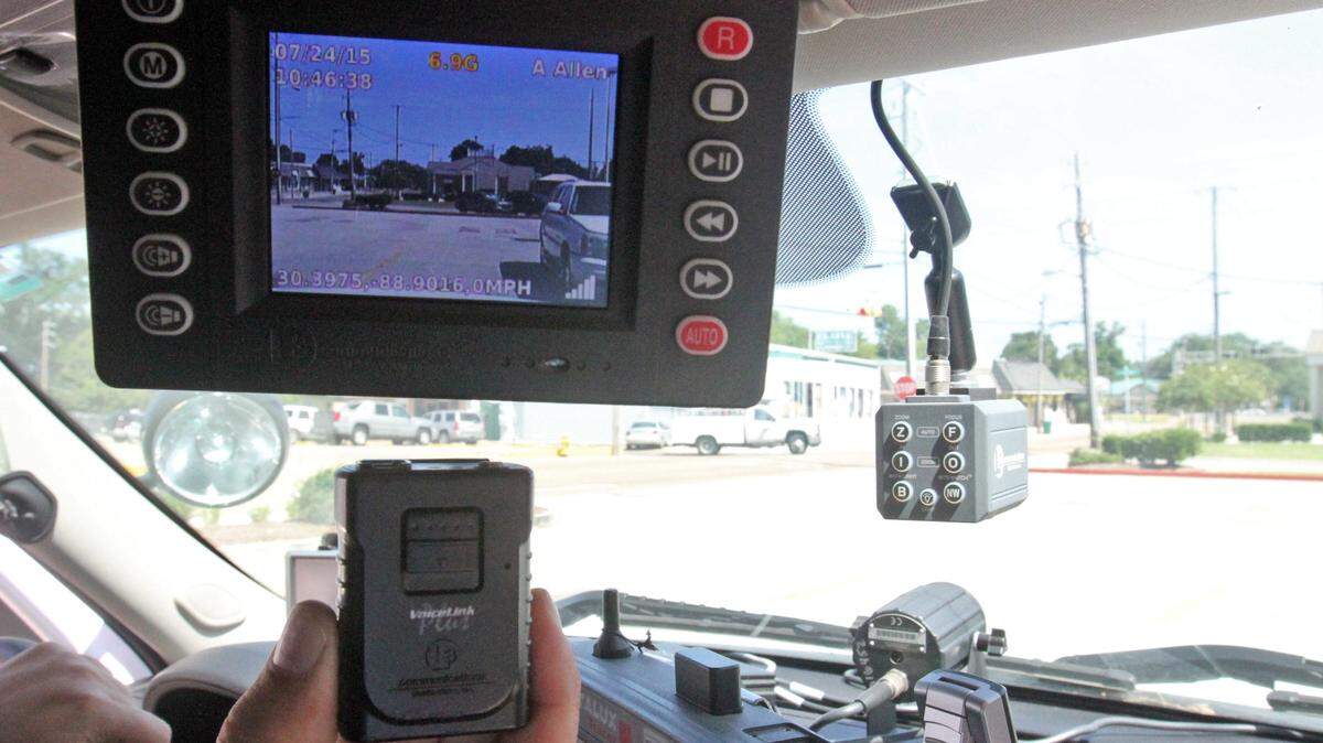 JOHN FITZHUGH/SUN HERALD 
 Biloxi police officers use the L3 Communications auto camera system which includes two cameras and a wireless microphone worn by the officer. The system sends the images to a server at the police department for storage.