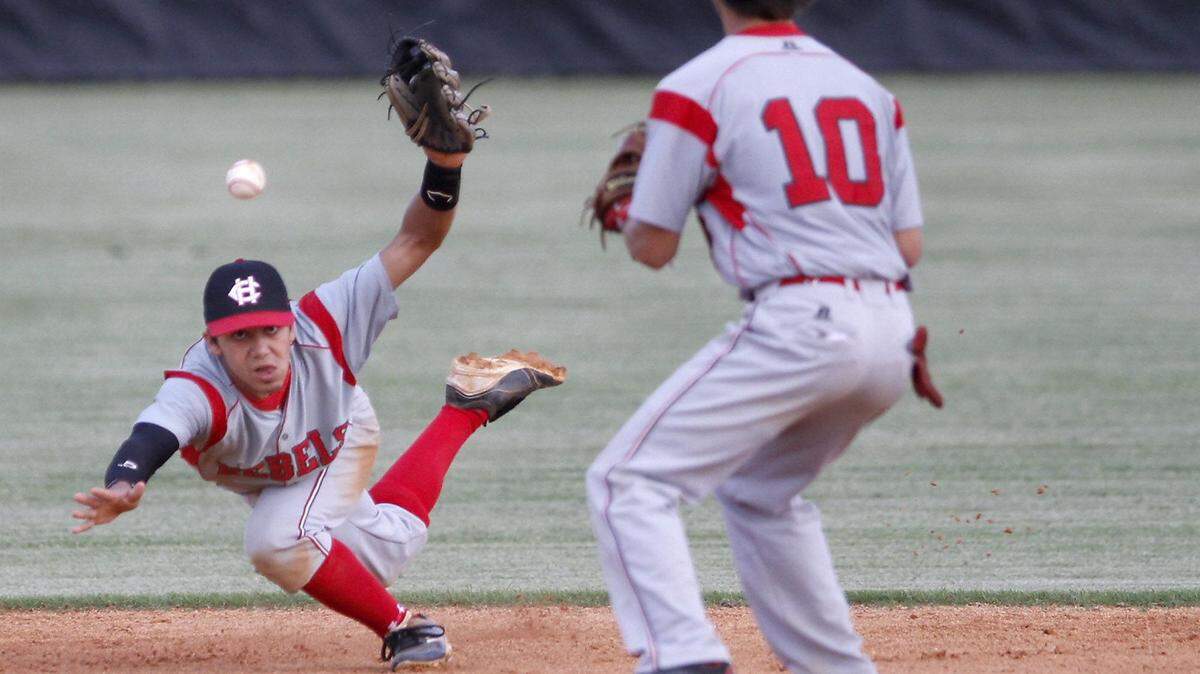 TIM ISBELL/SUN HERALD 
 Harrison Central shortstop Ian Colon tosses the ball to Logan Virgilio in an attempt to turn a double play against D'Iberville on April 21. Colon helped lead HCHS to a sweep Tuesday.
