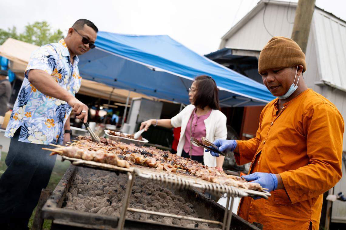 Pork skewers are made during Songkran at the Wat Buddhametta Mahabaramee in Gautier on Sunday, April 19, 2026.