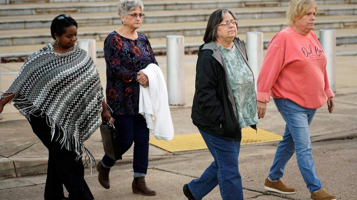 Wanda Farris, the mother of slain teenager Leesa Gray, second from right, is surrounded by supporters as she leaves the federal courthouse in Jackson, Miss., on Monday, Nov. 28, 2022, after they listened to several hours of arguments about Mississippi’s three-drug protocol for executions. Thomas Edwin Loden Jr. pleaded guilty in 2001 to capital murder, rape and four counts of sexual battery in the 2000 death of Gray, a 16-year-old waitress from north Mississippi. Loden is a plaintiff in the lawsuit. The Mississippi Supreme Court has scheduled his execution for Dec. 14, 2022. (AP Photo/Rogelio V. Solis)