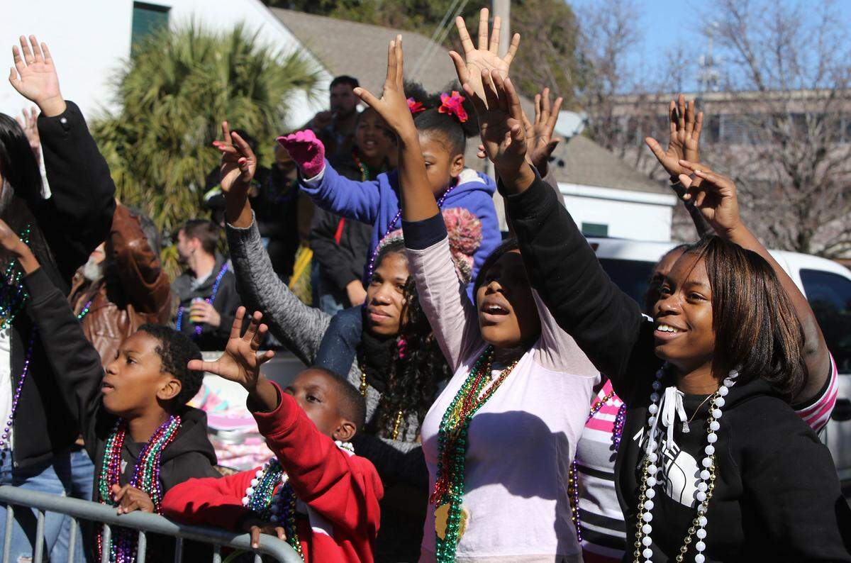 JOHN FITZHUGH/SUN HERALDRevelers call for beads during the Gulf Coast Carnival Association Mardi Gras Parade in Biloxi on Tuesday Feb. 9, 2016.