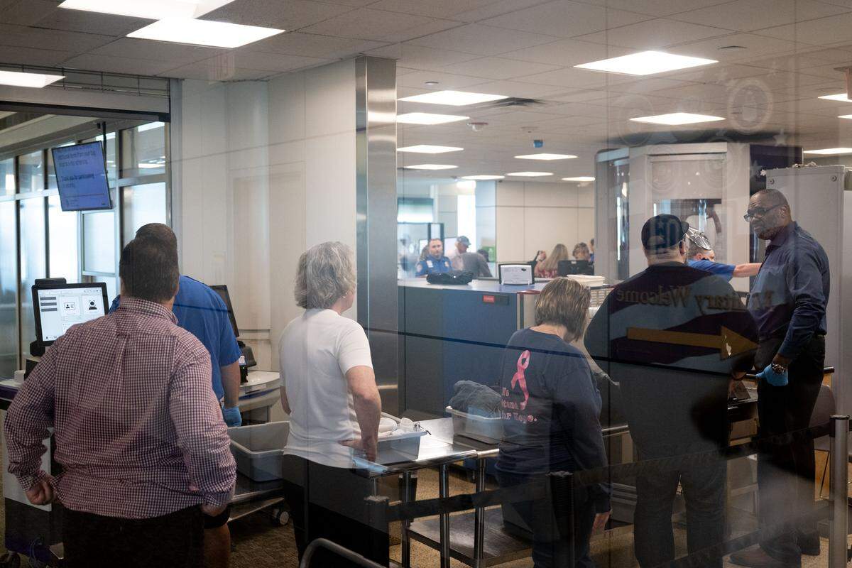 Passengers line up to have their bags checked at a TSA security checkpoint at Gulfport-Biloxi International Airport on Wednesday, March 25, 2026.