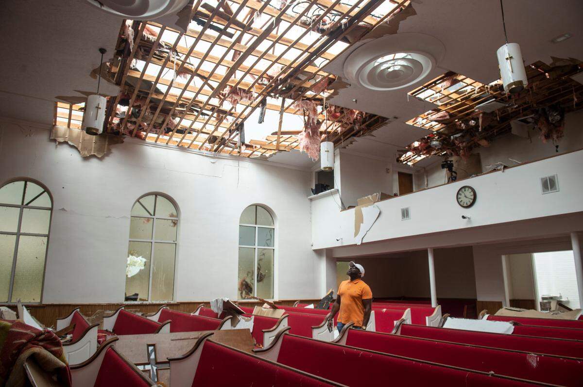 Pastor Kevin L. Henry, Sr poses for a photo inside First Baptist Missionary Church in Moss Point on Tuesday, June 20, 2023, after a tornado tore the roof off the building on Monday.