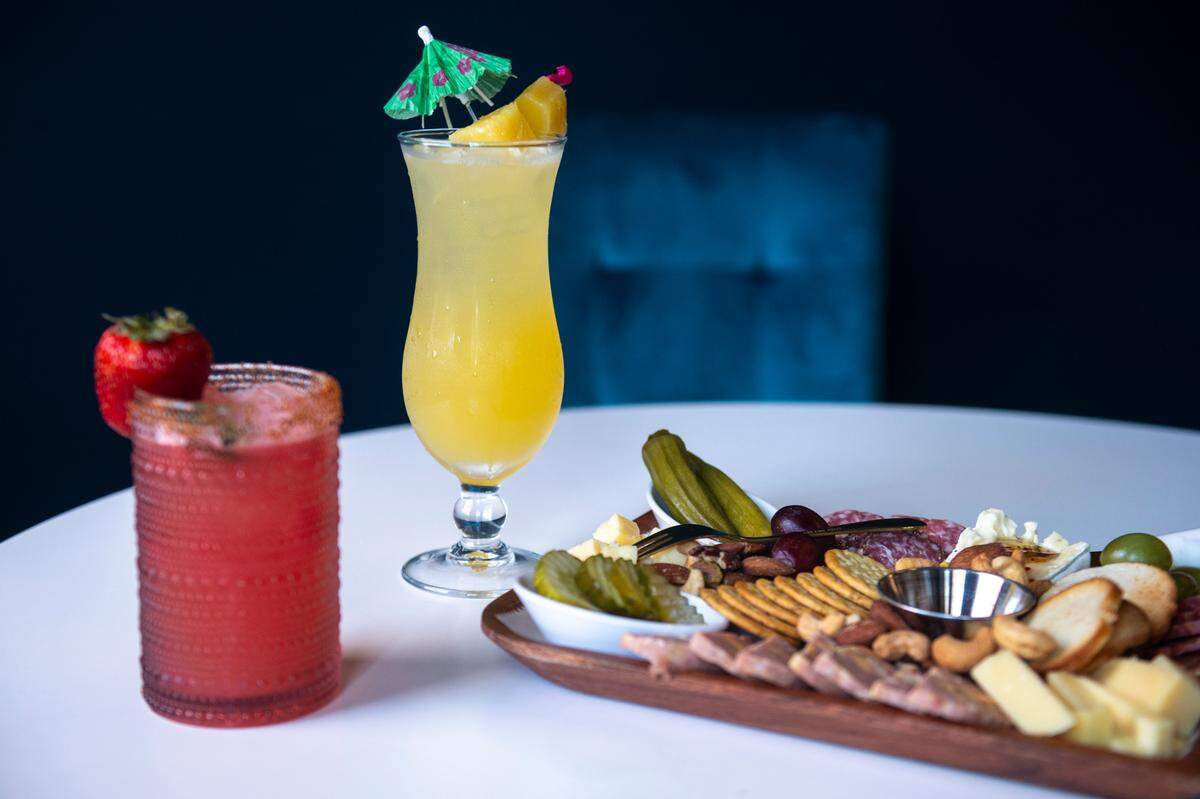 The Fire Bird Margarita, left, the Bird of Paradise, and the small charcuterie board at the Hen House, which serves drinks and small bites, in Bay St. Louis on Wednesday, May 29, 2024.