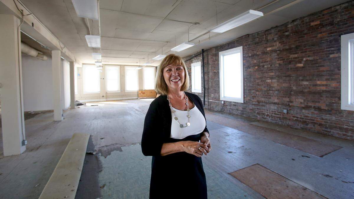 AMANDA McCOY/SUN HERALDLaurie Toups, executive director of the Gulfport Main Street Association, stands in the third floor space of the old Cadillac Building in downtown Gulfport on Thursday. New Orleans developer Vincent Marcello is investing in Gulfport and purchased the building, which houses Mosaic Restaurant & Bar on the ground floor. He is converting the third and fourth floors into luxury apartments.