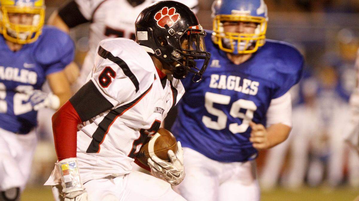 TIM ISBELL/SUN HERALD 
 Lumberton running back Daylon Burks tries to out run Resurrection's Jackson Byrd, Friday, Nov. 27, 2015.