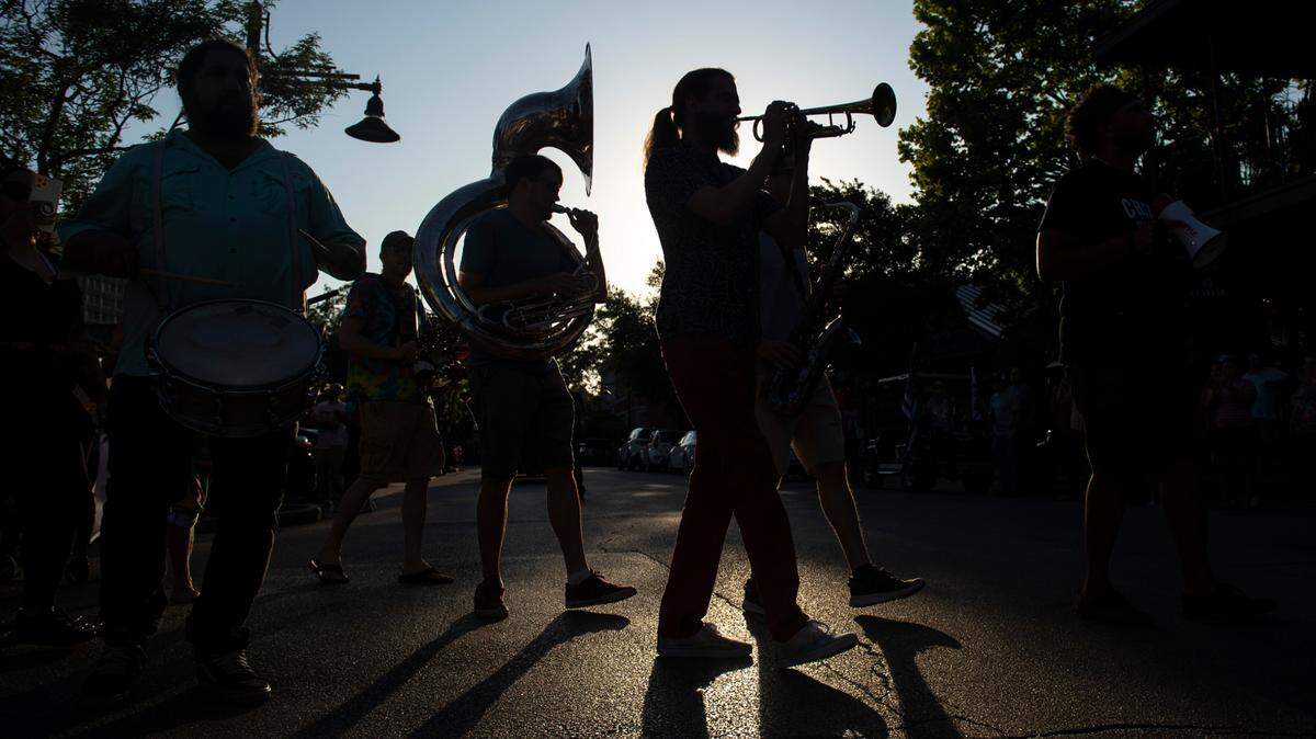 Blackwater Brass, a jazz band, leads the second-line funeral for Carl the rooster down Government Street in Ocean Springs on Tuesday, May 10, 2022.