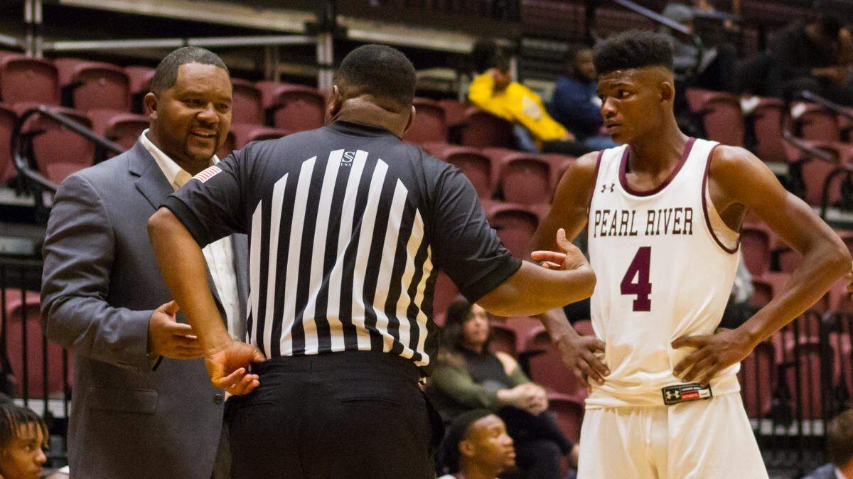 Pearl River coach Chris Oney, left, talks with an official as guard Earl Smith looks on during a game this season.