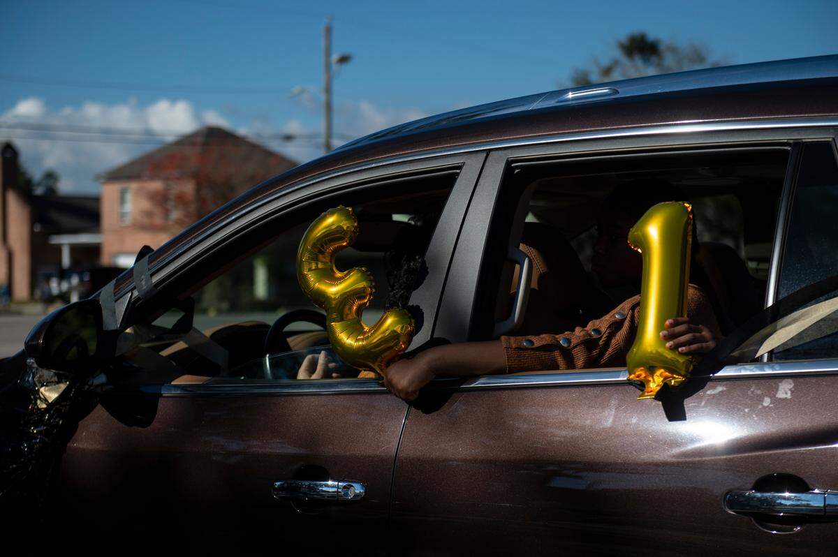 Parishioners hold balloons out of their car window for Pastor Seymour Venson Adolph, Jr.’s 31 years of leading Handsboro Baptist Church during a parade for his retirement in Gulfport on Saturday, Dec. 4, 2021.