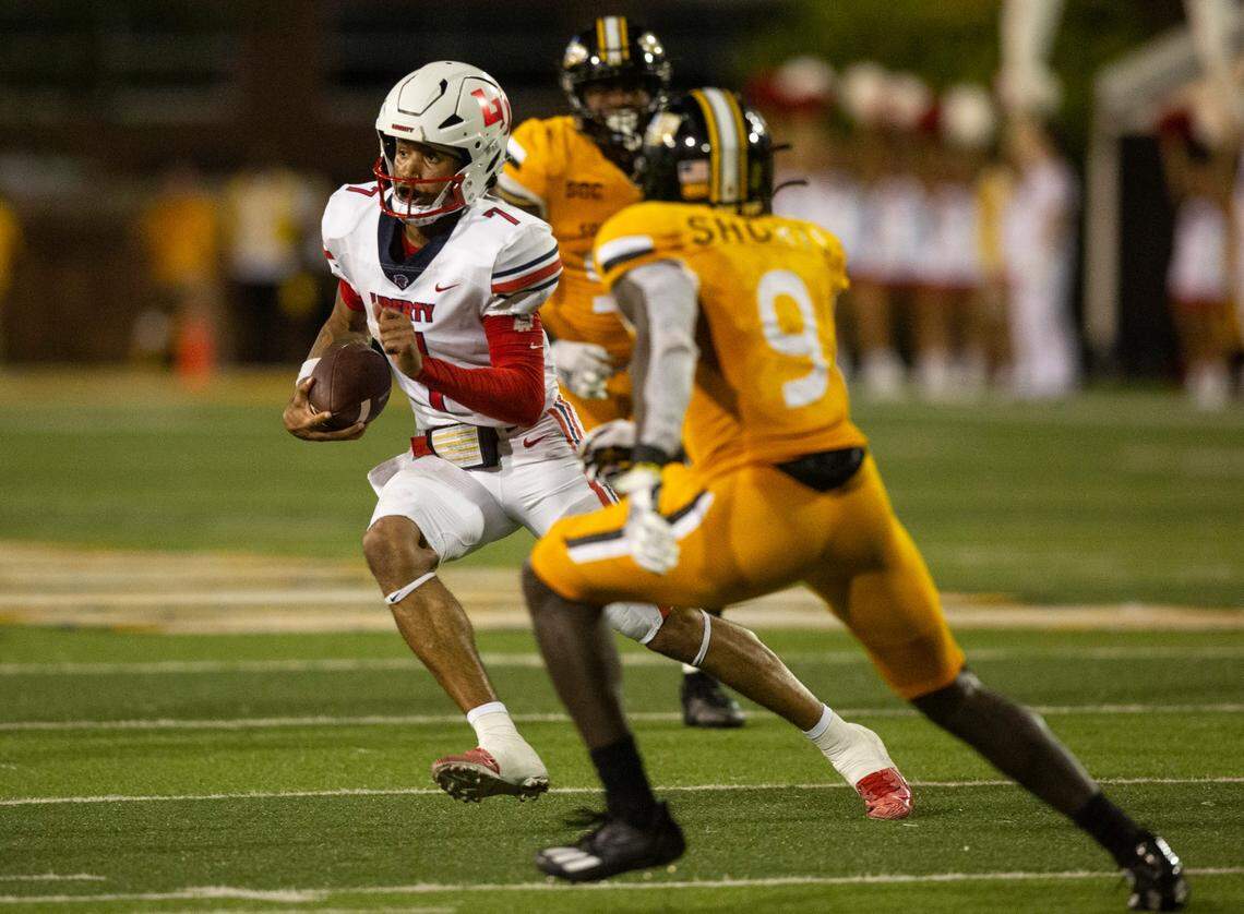 Liberty quarterback Kaidon Salter (7) evades Southern Mississippi defensive back Malik Shorts (9) during the second half of an NCAA college football game in Hattiesburg, Miss., Saturday, Sept. 3, 2022. Southern Mississippi won 27-8. (Hannah Ruhoff/The Sun Herald via AP)